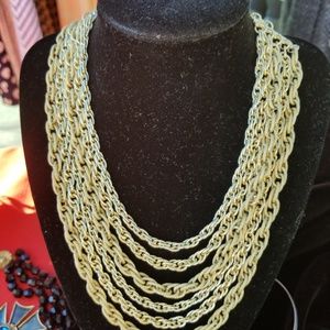 Multi stran gold tone necklace